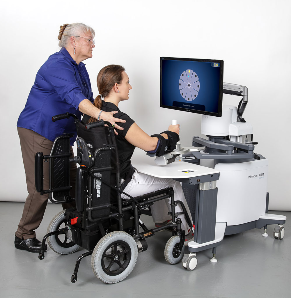 Therapist with InMotion Arm and Patient in a Powerchair
